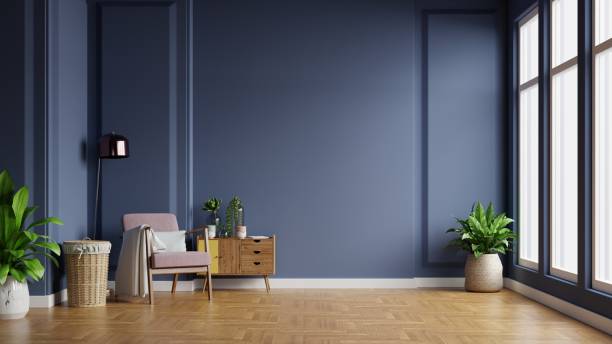 istock Interior of light room with armchair on empty dark blue wall background. 1297327189
