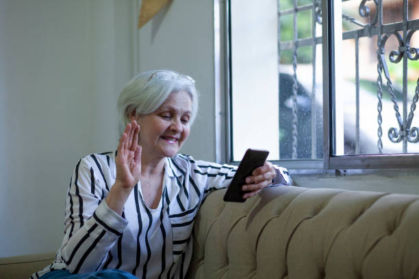 istock 65-year-old woman makes video call on her cell phone 1297329333