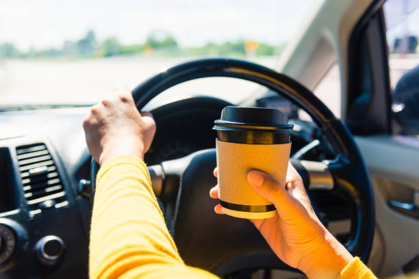 istock woman drinking hot coffee takeaway cup inside a car 1297330475