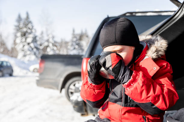 little boy drinking hot chocolate at the car after skiing - ski resort winter sport apres ski ski slope imagens e fotografias de stock