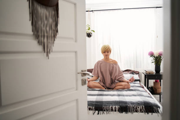 istock Woman in casual clothes meditating 1297331774
