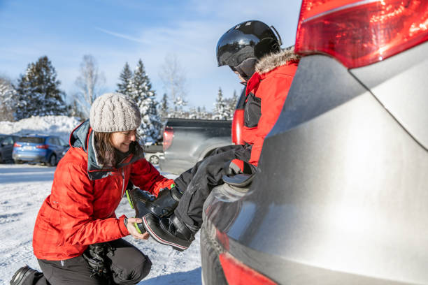 istock Mother and Son Preparing For Ski During Covid-19 Pandemic 1297332042