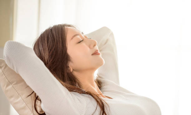 istock Relaxed young woman leaned on couch and closed eyes 1297332082