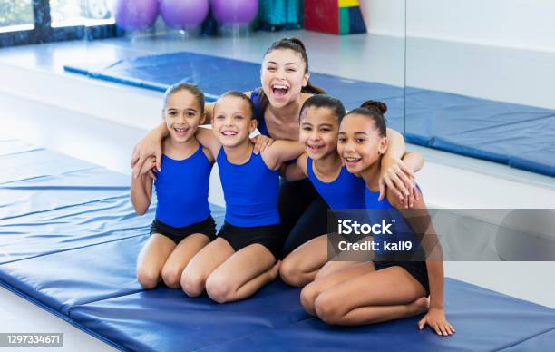 Gymnastics Coach With Four Girls In Gym Stock Photo - Download Image Now - Gymnastics, Child, Instructor