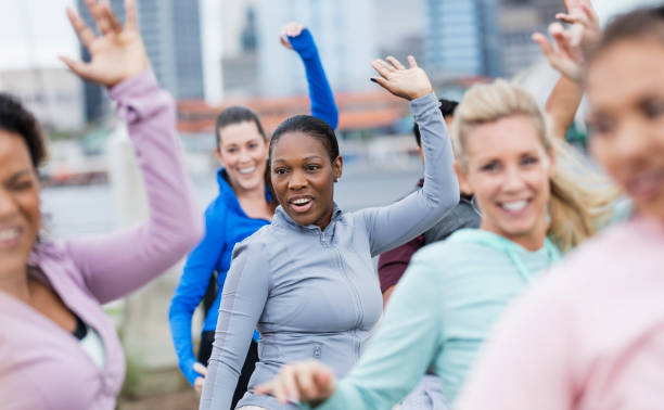 istock Multi-ethnic group of women taking dance exercise class 1297334715