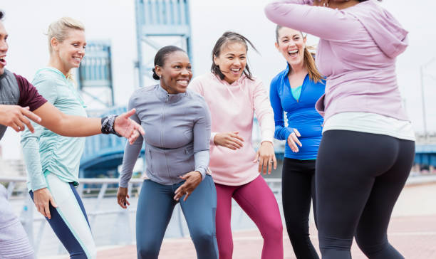 istock Multi-ethnic group of adults dancing outdoors 1297335372