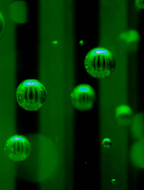 istock Green Reflective Bubbles Inside of a Glass Light Tube Abstract 1297335538