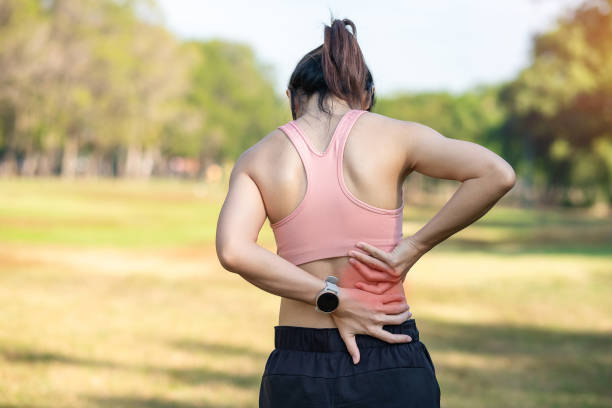 young adult female with his muscle pain during running. runner woman having back body ache due to piriformis syndrome, low back pain and spinal compression. sports injuries and medical concept - low back imagens e fotografias de stock