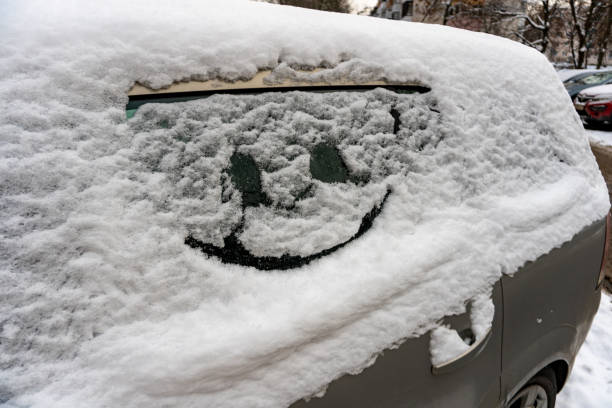 istock Drawn smile on car glass on snow 1297338985