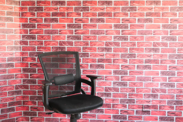 istock black empty chair against a wall indoor 1297340558
