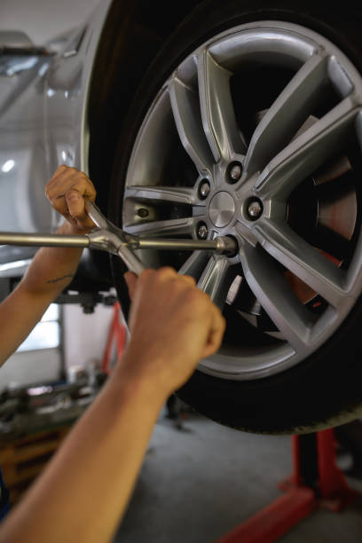 istock Screwdriver screwing disc on car wheel 1297341521
