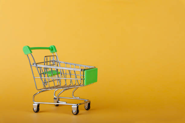 istock Empty supermarket shopping grocery cart on colored background 1297341604