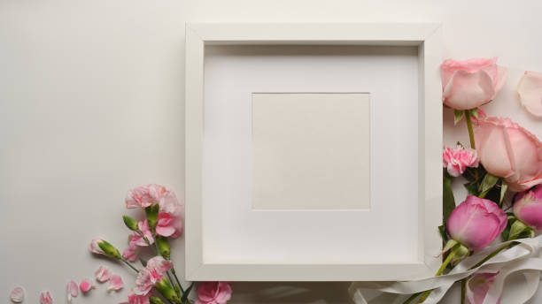istock Top view of mock up frame and pink flower decorated on table 1297342654