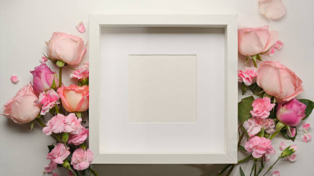 istock Top view of mock up frame and pink flower decorated on the table 1297342665