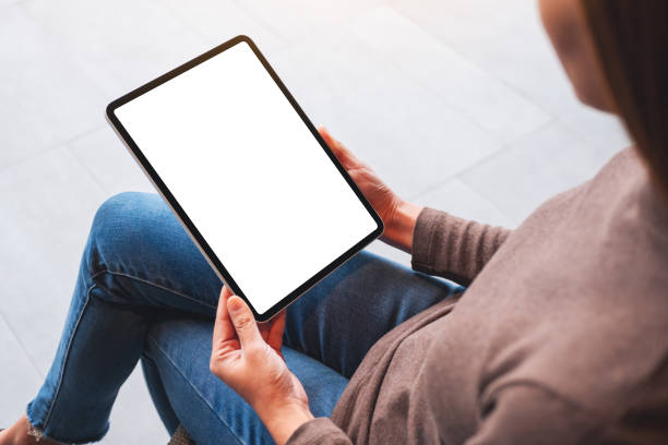 istock a woman holding digital tablet with blank white desktop screen 1297343317