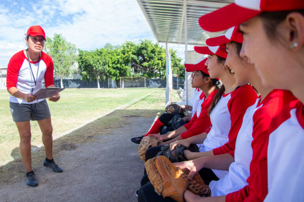 istock Teenage women on bench with coach 1297347564