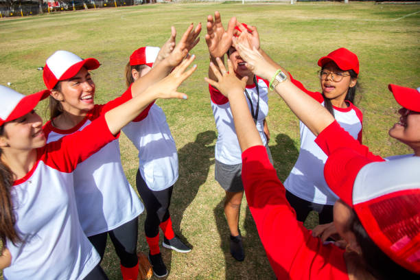 istock femenil baseball team celebrating 1297347623