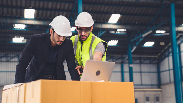 istock Two factory workers working and discussing manufacturing plan in the factory . 1297348158
