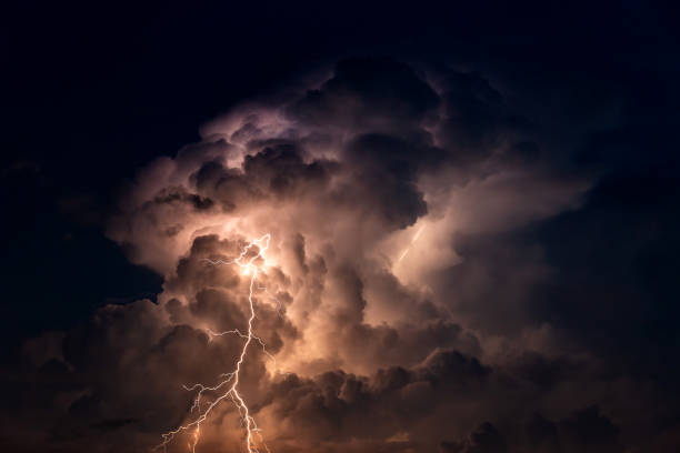 istock Dark cloud at  night with thunder bolt. Heavy storm bringing thunder, lightnings and rain in summer. 1297348333