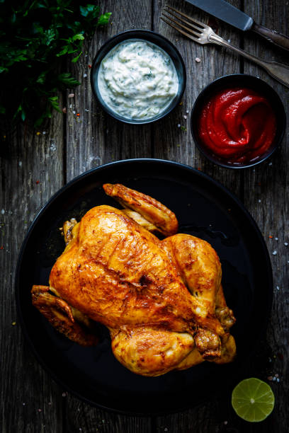 istock Roast chicken on wooden table 1297349531