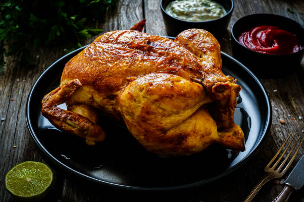 istock Roast chicken on wooden table 1297349547