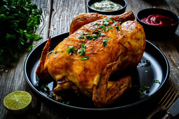 Roast chicken on wooden table Roast chicken on wooden table comprehensive stock pictures, royalty-free photos & images
