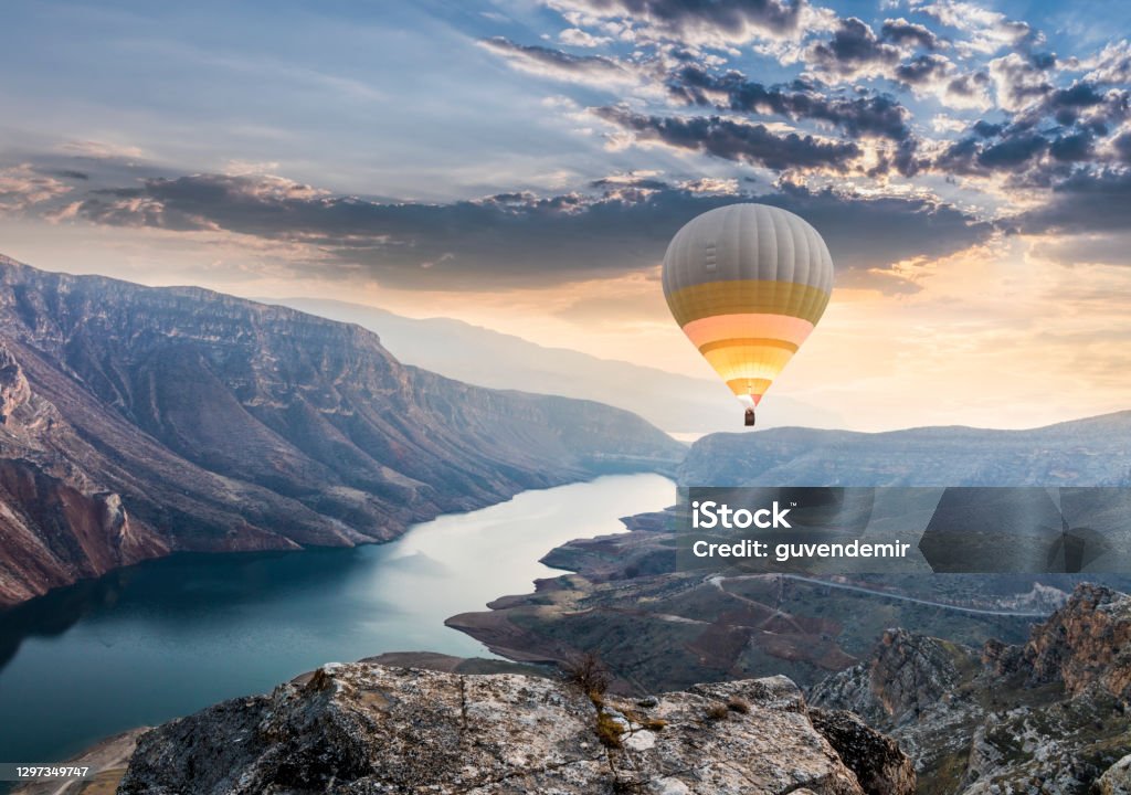 Hot air balloons flying over the Botan Canyon in TURKEY Landscape - Scenery Stock Photo
