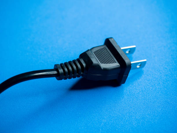 istock Closeup shot of a black American plug on a blue surface 1297353642