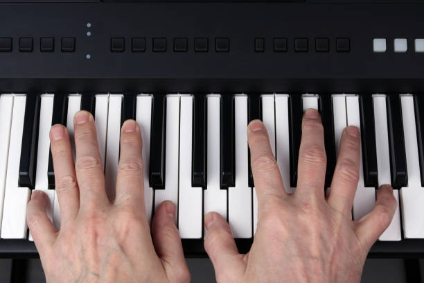 istock Man plays  on the keyboard of the   synthesizer 1297357882