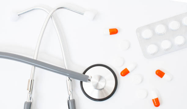 istock stethoscope, red heart sheet of paper for notes on a white background on the table 1297358568