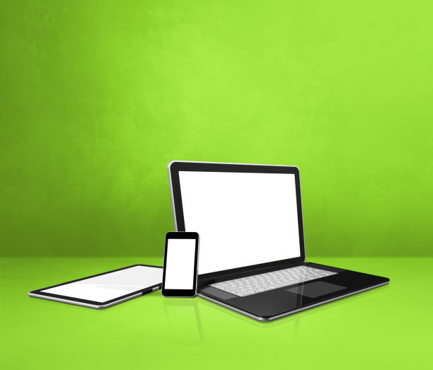 istock Laptop, mobile phone and digital tablet pc on green office desk 1297358975