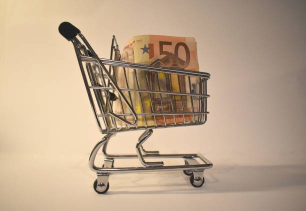 istock Shopping cart and euros. Concept showing an increase in costs for basic shopping while a large part of population face a loss of revenues. 1297359043