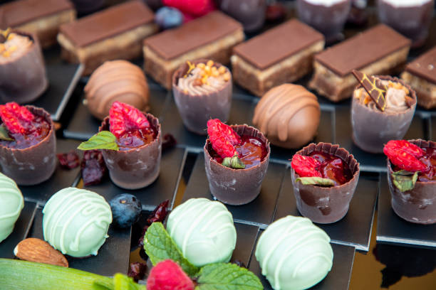 istock Truffles on buffet, various tastes, raspberry jelly chocolate cupcakes in focus 1297359902
