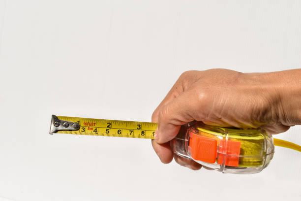 istock Tape measure on white background with copy space 1297362827