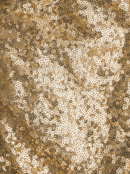 istock vertical background: fabric with sewn sequins. color Champagne sailing 1297362907