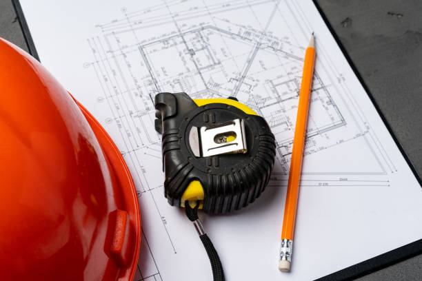 istock Hardhat and blueprints on wooden background top view 1297364228