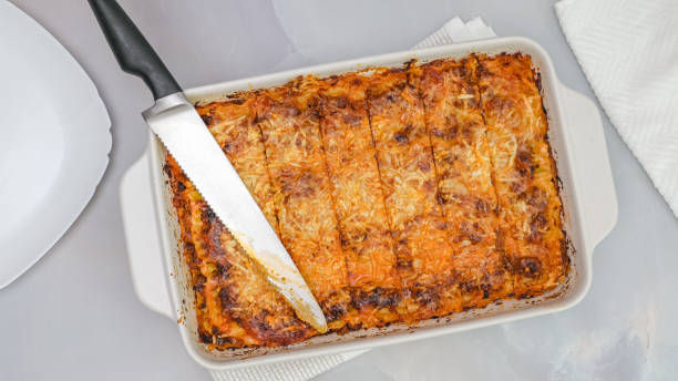 istock Fresh baked beef lasagna  in baking dish close up on marble kitchen table directly from above 1297365007