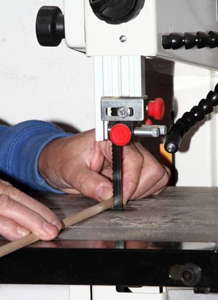 istock Man with an electrical jig saw in an action at the workshop 1297365876