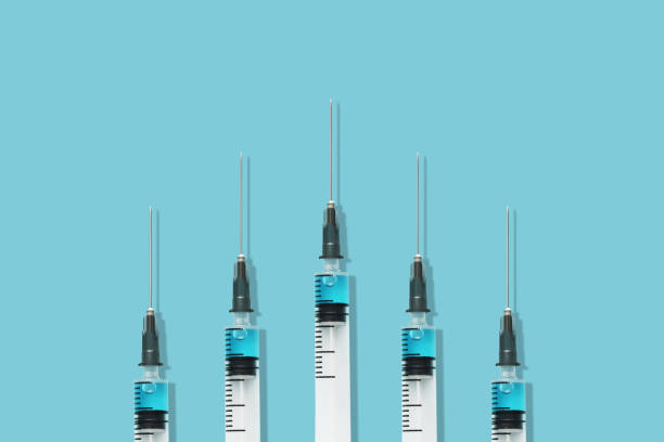 istock Group of syringes vaccines on the blue background 1297366643