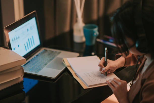 istock asian chinese beautiful woman using laptop working from home in study room writing headset 1297368227