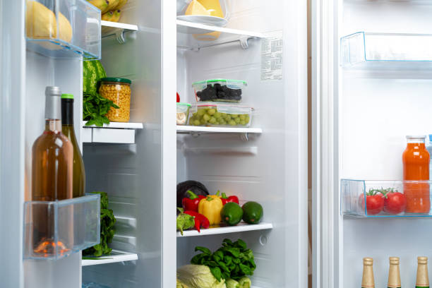 istock Open fridge full of fruits, vegetables and drinks 1297369107