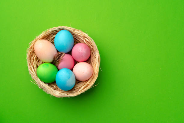 istock Easter eggs in a nest on green background 1297369834