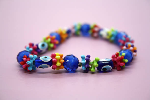 istock A bracelet made of beads on a pink background. 1297370434