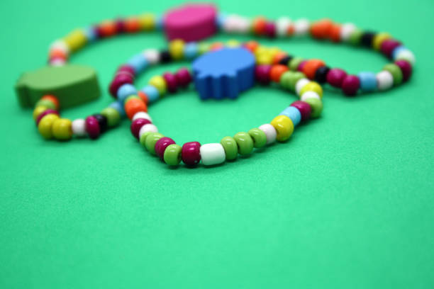 istock A bracelet made of beads on a pink background. 1297370468