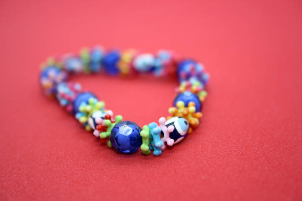 istock A bracelet made of beads on a red background. 1297370475