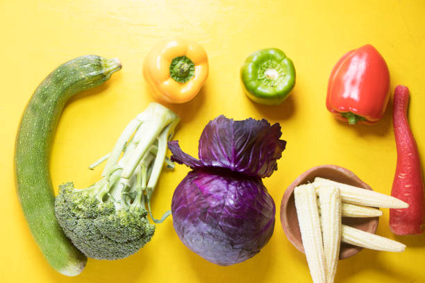 istock Healthy raw fresh vegetables placed in yellow background 1297372319
