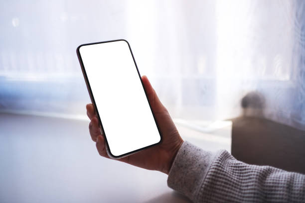 istock a woman holding mobile phone with blank white desktop screen 1297372669