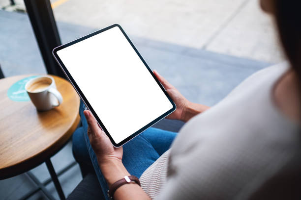 istock a woman holding digital tablet with blank white desktop screen 1297372697