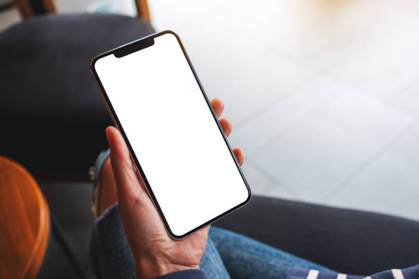 istock a woman holding mobile phone with blank white desktop screen 1297372701