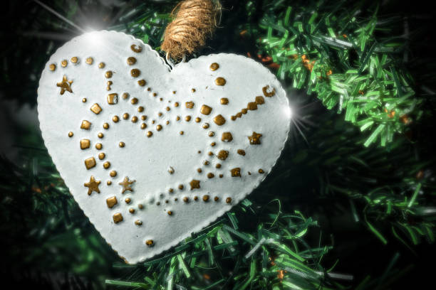 istock White and Gold Heart Hanging on a Christmas Tree 1297373370